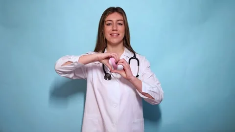 Smiling Doctor Making Heart Shape with Hands Stock Footage 297675207
