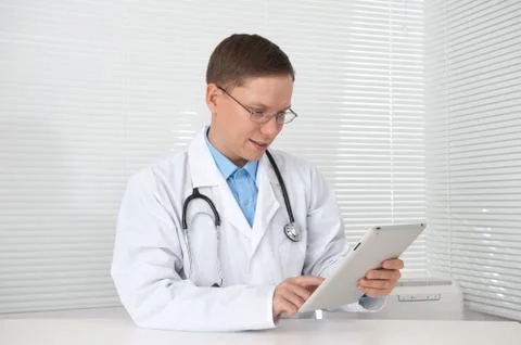 Smiling doctor with tablet computer Stock Photos