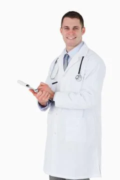 Smiling doctor taking notes Stock Photos