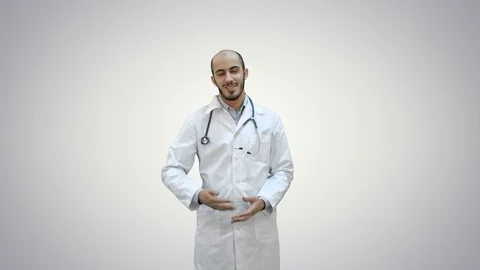 Smiling doctor talking to the camera on white background Stock-Footage 73637723