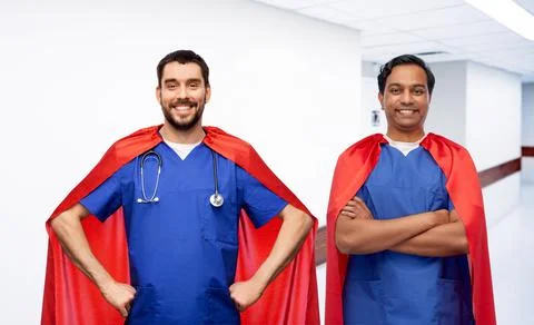 Smiling doctors or male nurses in superhero capes Stock Photos