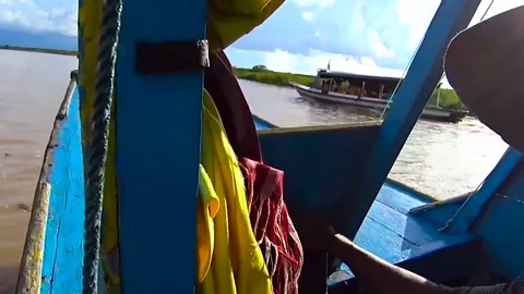 Smiling driver of a Tipical boat in tnole sap, Cambodia Stock Footage 77846015