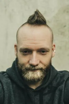 Smiling dude in close up, looking down Stock Photos
