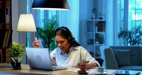 Smiling during video call, Indian businesswoman attends meeting using laptop Stock-Footage 342573549