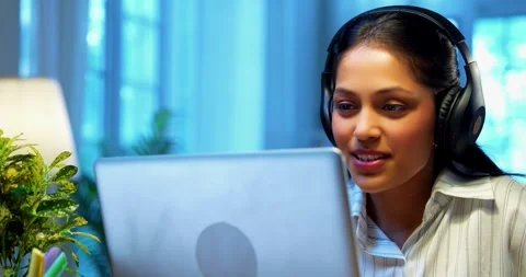 Smiling during video call, Indian businesswoman attends meeting using laptop Stock-Footage 342573579