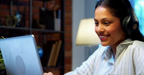 Smiling during video call, Indian businesswoman attends meeting using laptop Stock-Footage 342573589