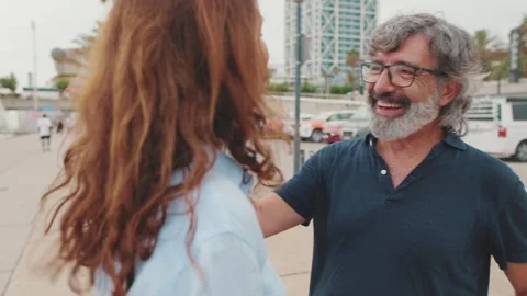 Smiling elderly couple talking while standing in marina on yacht background Stock Footage 255965129