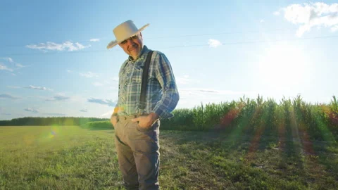 Smiling elderly farmer portrait. Agronomist wearing straw hat looking in camera Stock Footage 158928186