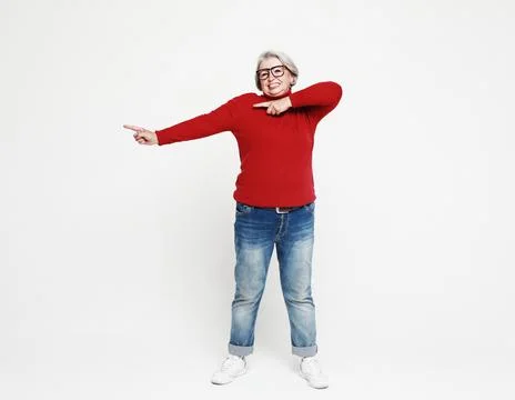 Smiling elderly gray-haired blonde woman lady 60s years old in red casual Stock Photos
