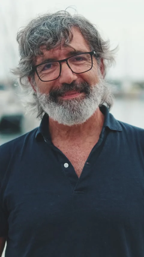 Smiling elderly man standing on pier in marina and looking at the camera Stock Footage 250841907