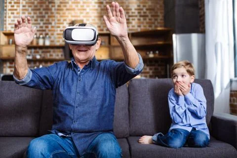 Smiling elderly man wearing VR glasses Stock Photos