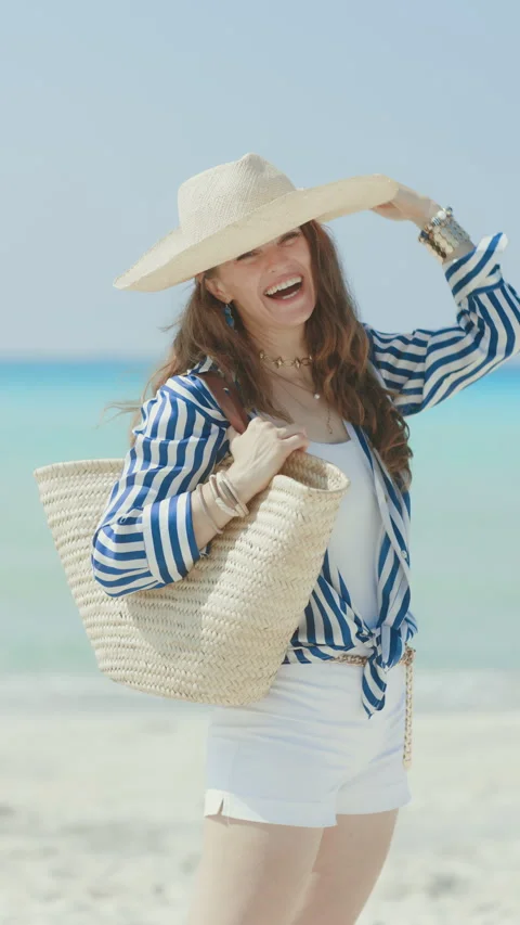 Smiling elegant 40 years old woman on seashore Stock Footage 276713853