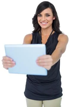 Smiling elegant dark haired model holding her tablet Stock Photos