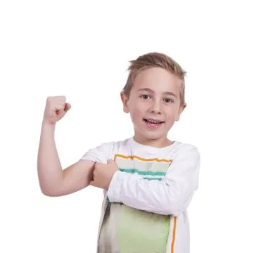 Smiling elementary boy flexing biceps Foto stock