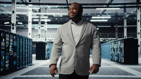 Smiling employee walking in high tech data center Stock Photos