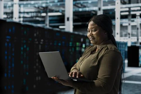 Smiling engineer does maintenance on data center electronics 스톡 사진