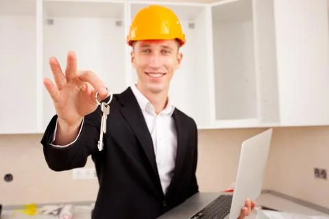 Smiling engineer gives keys Foto stock