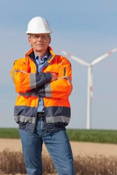 Smiling engineer with hard hat and protective clothing Фото