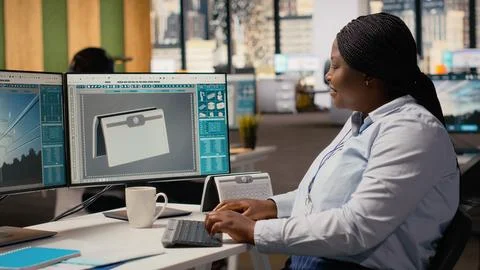 Smiling engineer in office pleased after developing innovative solar device Stock Photos
