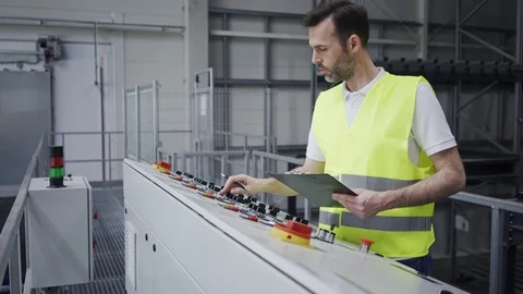 Smiling engineer operating machine console in factory Stock Footage 108450748