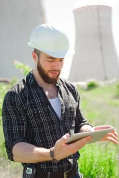 Smiling engineer using a tablet in a facility Stock Photos