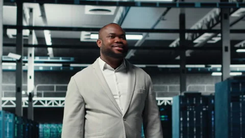 Smiling engineer walking in data center, checking hardware for system stability Video stock 311961433