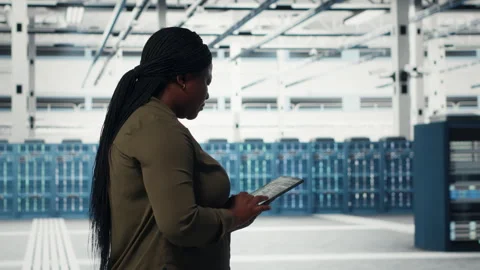 Smiling engineer walking in data center with laptop, checking hardware Stock Footage 317204871