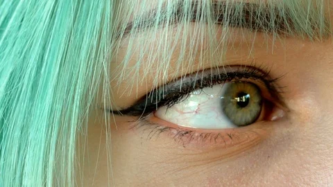 Smiling eye macro shot of green hair young girl Stock Footage 91684871