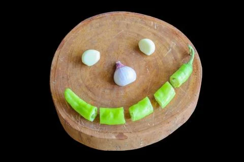Smiling face made of vegetables and chopping block Stock Photos