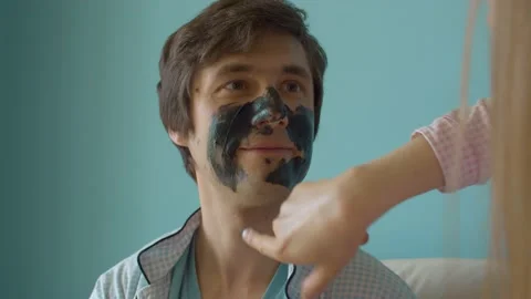 Smiling face of a man getting face mask Video stock 130996682