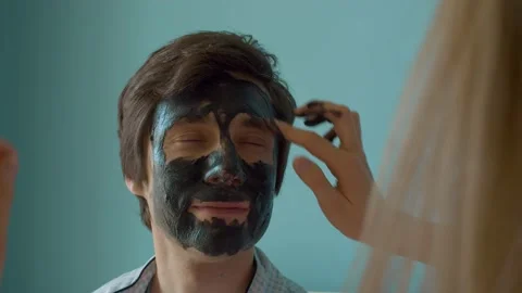 Smiling face of a man getting face mask Stock Footage 130997011