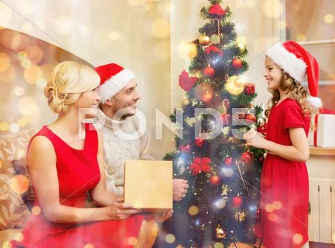 Smiling family decorating christmas tree Stock Photos