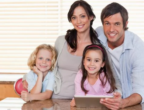 Smiling family using a tablet computer together Stock Photos