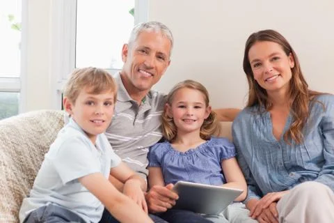 Smiling family using a tablet computer Foto stock