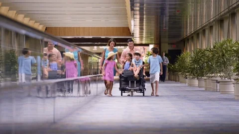 Smiling family walking with baggage cart in airport Stock Footage 78072854