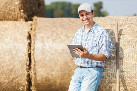 Smiling farmer using a tablet Stock Photos