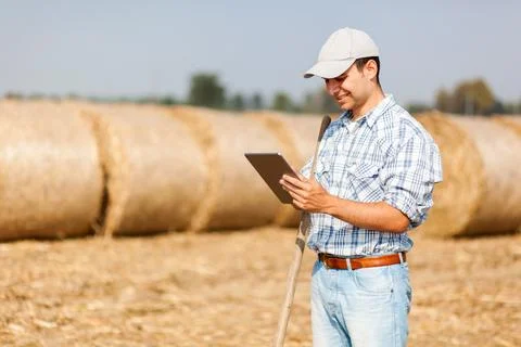 Smiling farmer using a tablet Stock Photos
