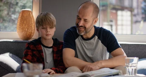 Smiling father explains son homework Stock Footage 128838087
