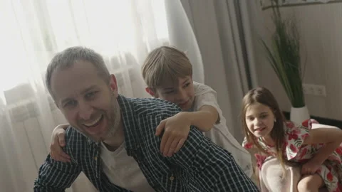 Smiling father having fun with cute children at home Stock Footage 157331246