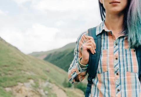 Smiling female backpacker in the mountains. Stock Photos
