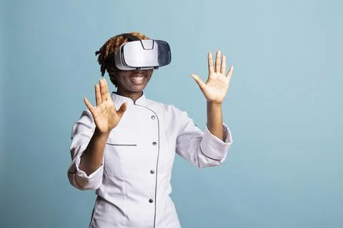 Smiling female chef exploring virtual reality in studio Stock Photos