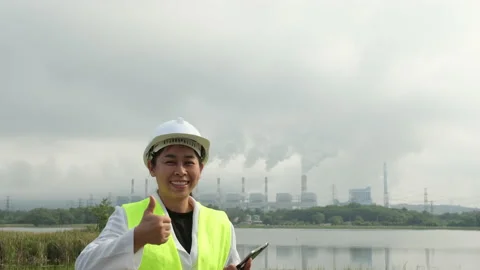 Smiling female chief engineer standing at coal plant in the morning. Stock Footage 223639282
