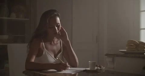Smiling female composer writing in notebook while composing music Stock Footage 249977144
