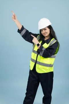 Smiling Female Construction Worker Gesturing Upwards 스톡 사진