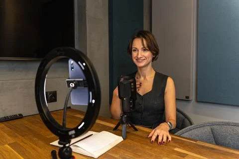 Smiling female content creator gesturing during video recording with Stock Photos
