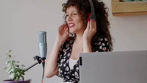 Smiling female content creator streaming at home Stock Footage 150894637