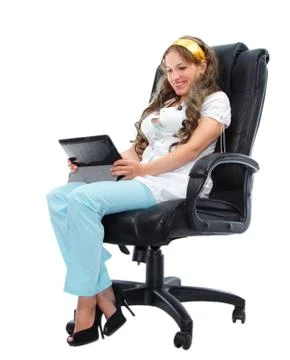 Smiling female doctor with tablet computer sitting in armchair Stock Photos
