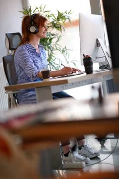 Smiling female drawing on computer Stock Photos