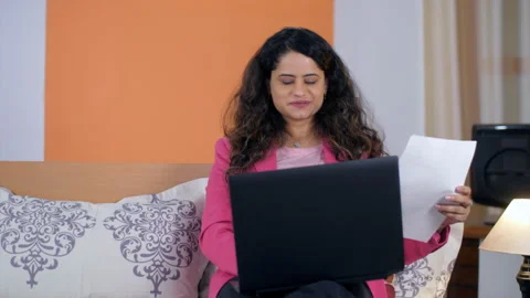 A smiling female employee talking to a client on a video call on her laptop Stock Footage 163703403