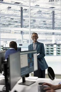 Smiling female engineer verifying PCB factory microelectronics Stock Photos